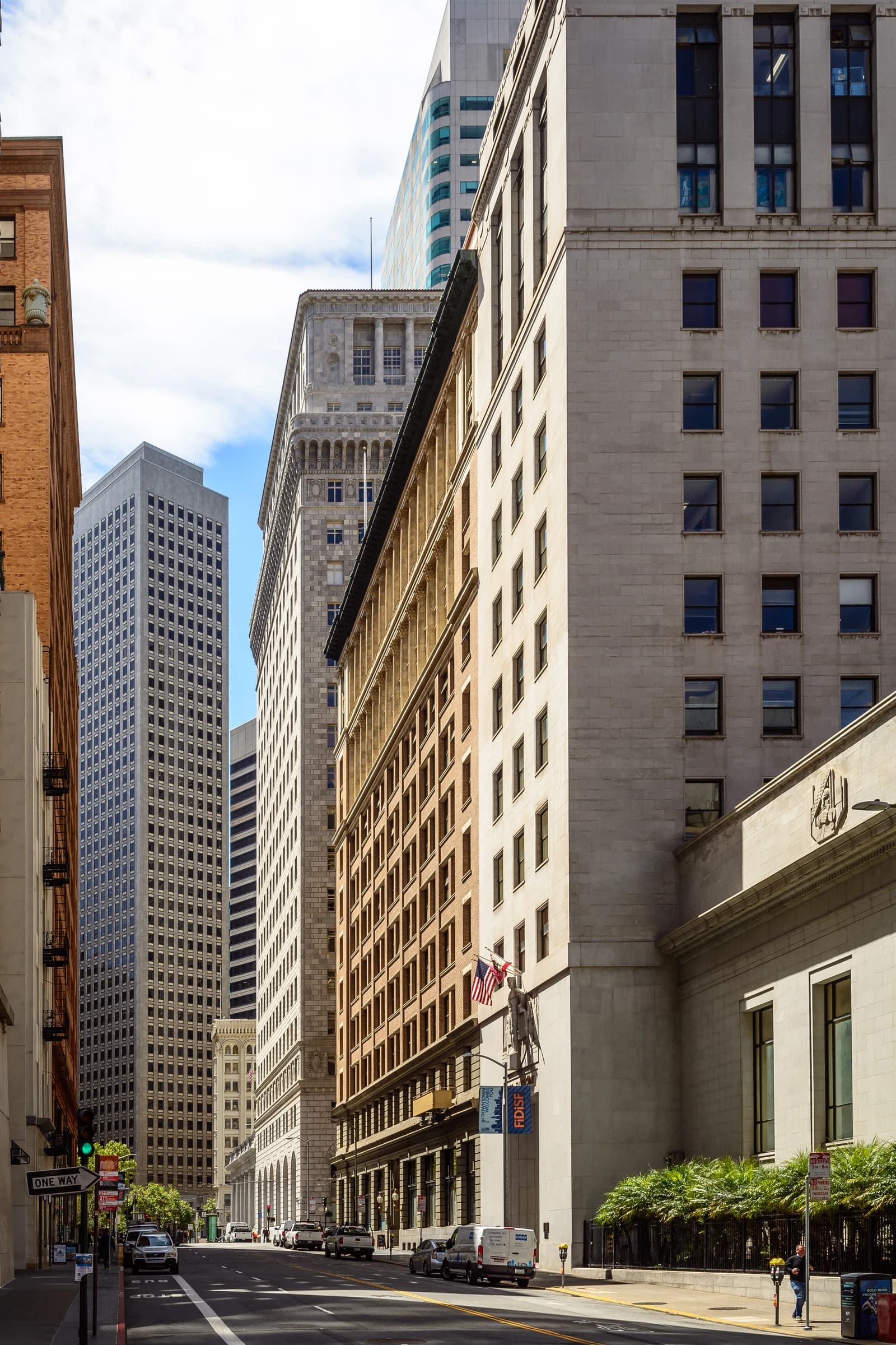 Financial District street with tall buildings and parked cars in San Francisco.