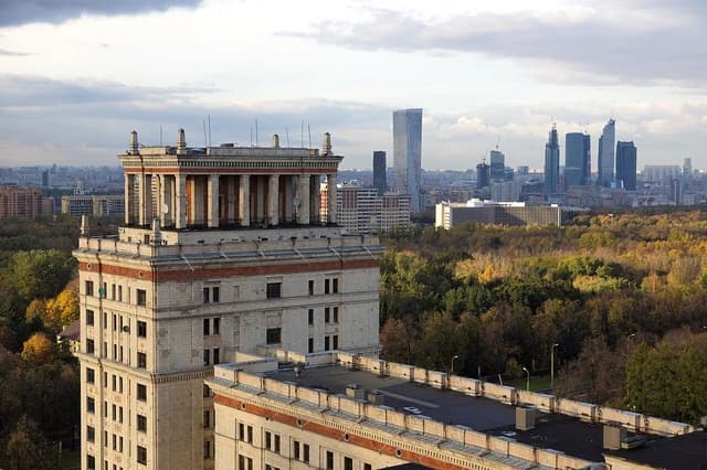 Moscow State University's northern residential building, city skyline, and autumn foliage.