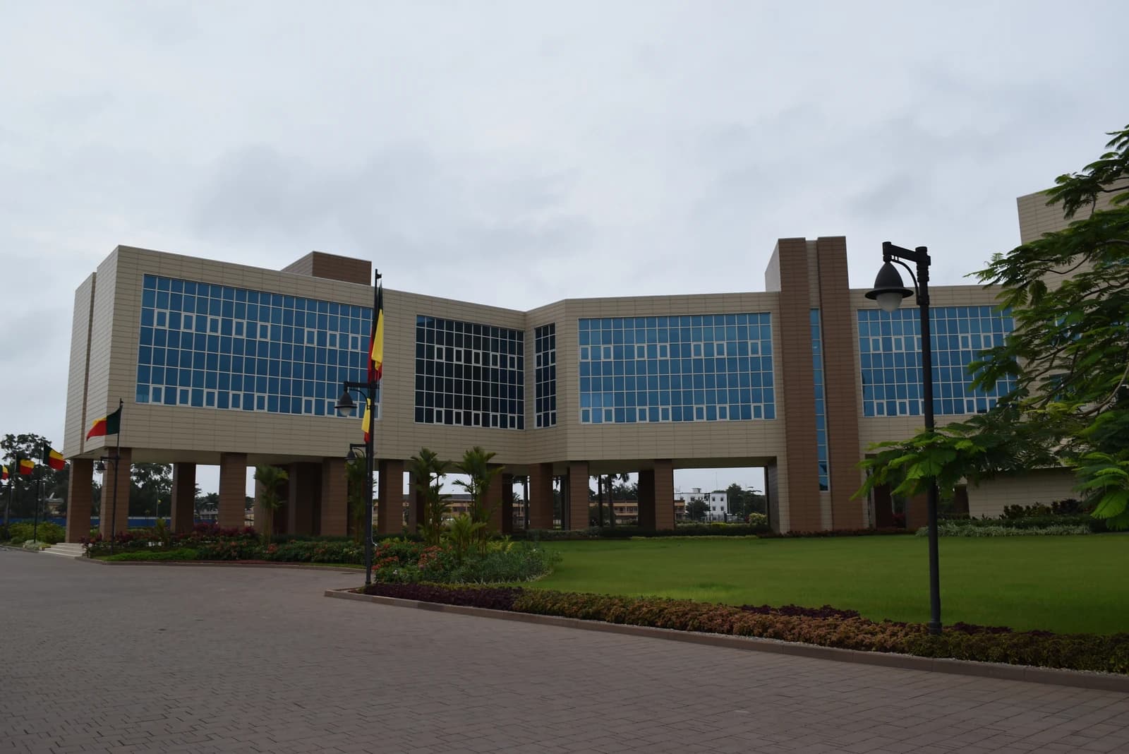 Palais de la Marina, Presidential Palace of Benin, with flags and manicured lawn.