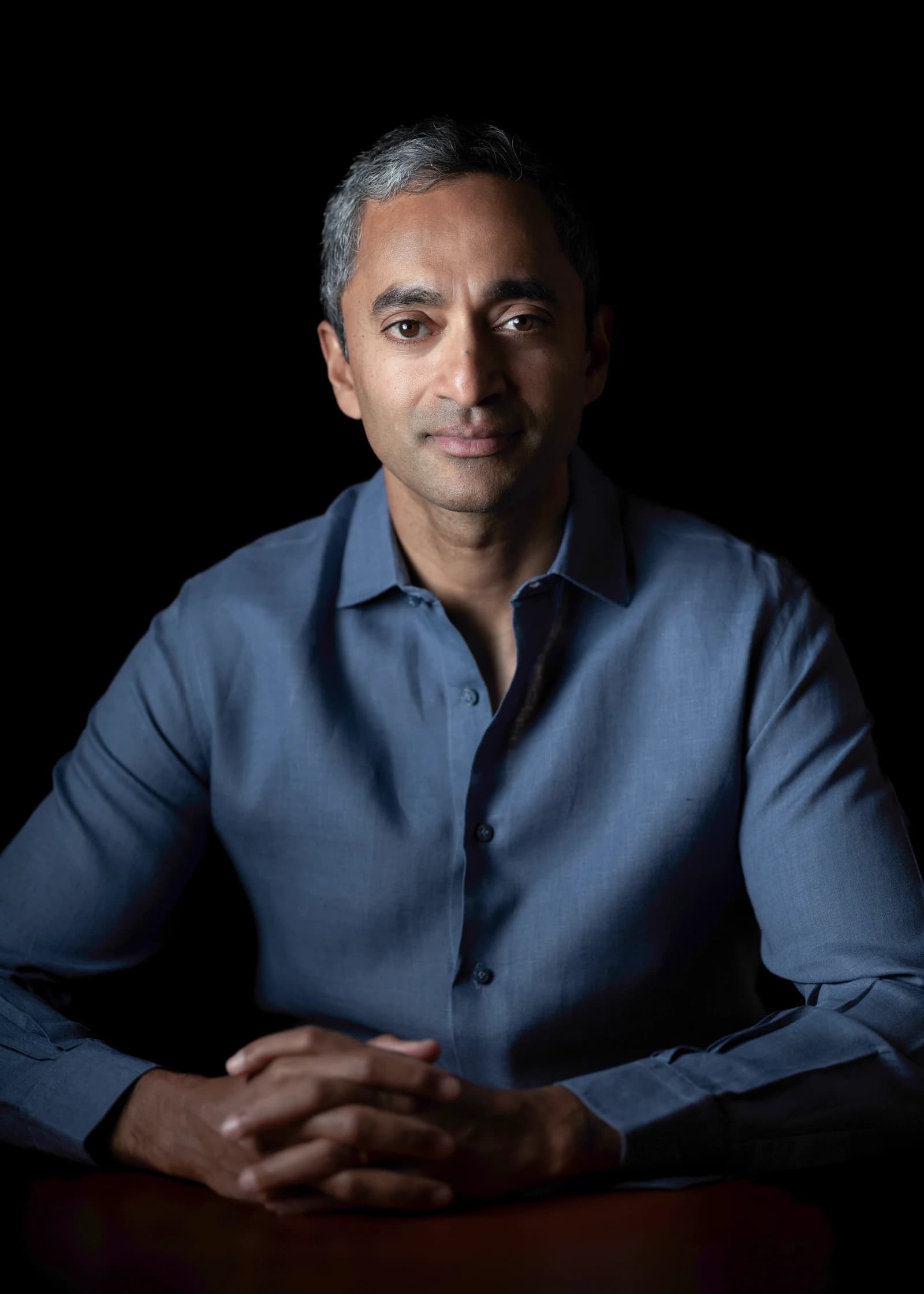 Chamath Palihapitiya, venture capitalist, poses for a portrait against a dark background.