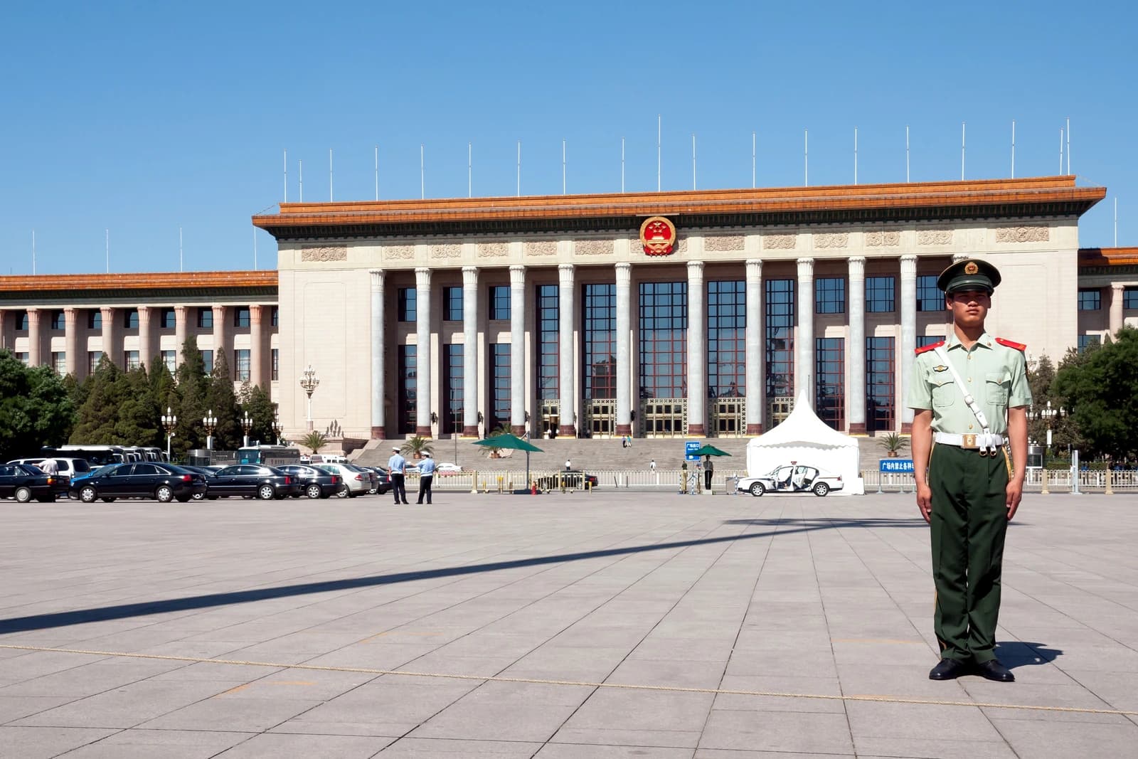 Chinese soldier stands guard in front of the Great Hall of the People.
