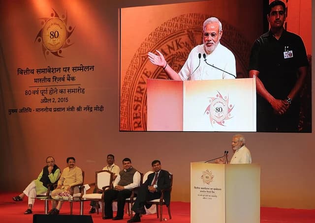 Prime Minister Narendra Modi speaking at a podium at an RBI conference.