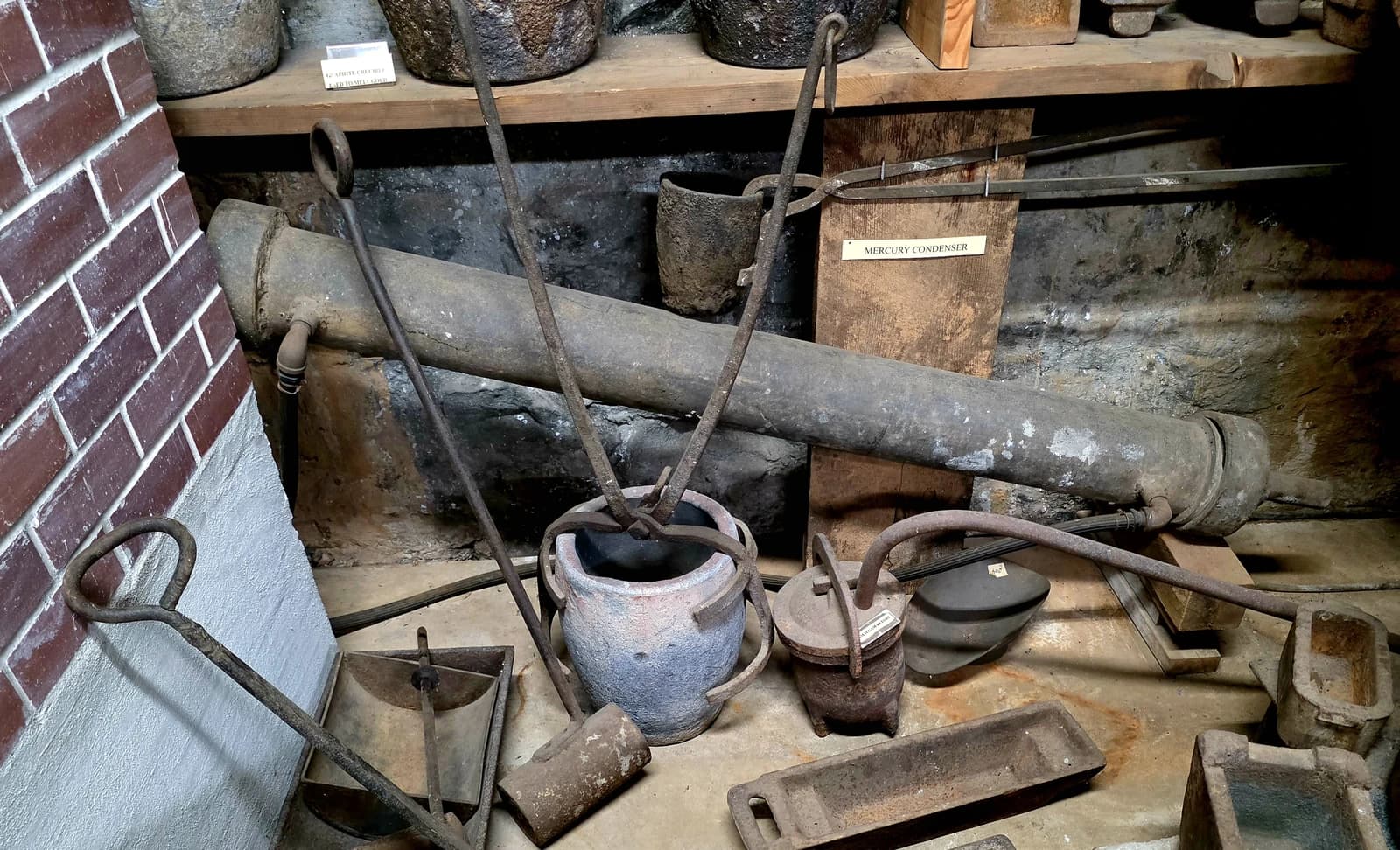 An old mercury condenser and various mining tools are displayed.
