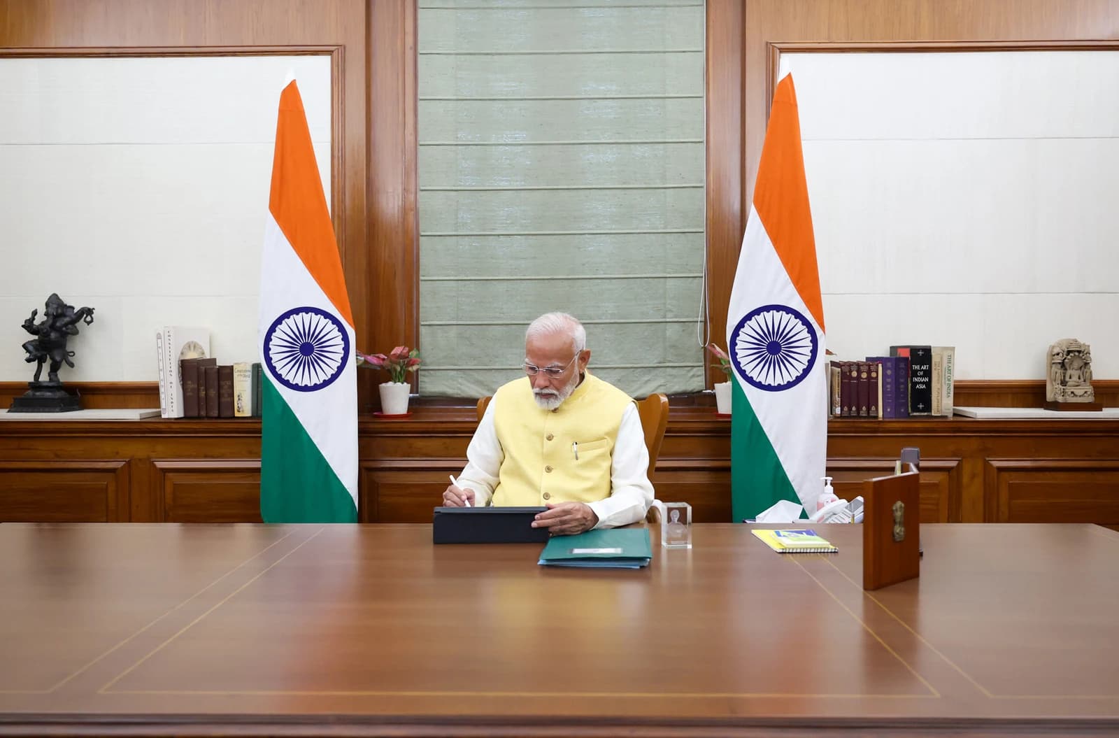 Narendra Modi, Prime Minister of India, working at his desk in his office.