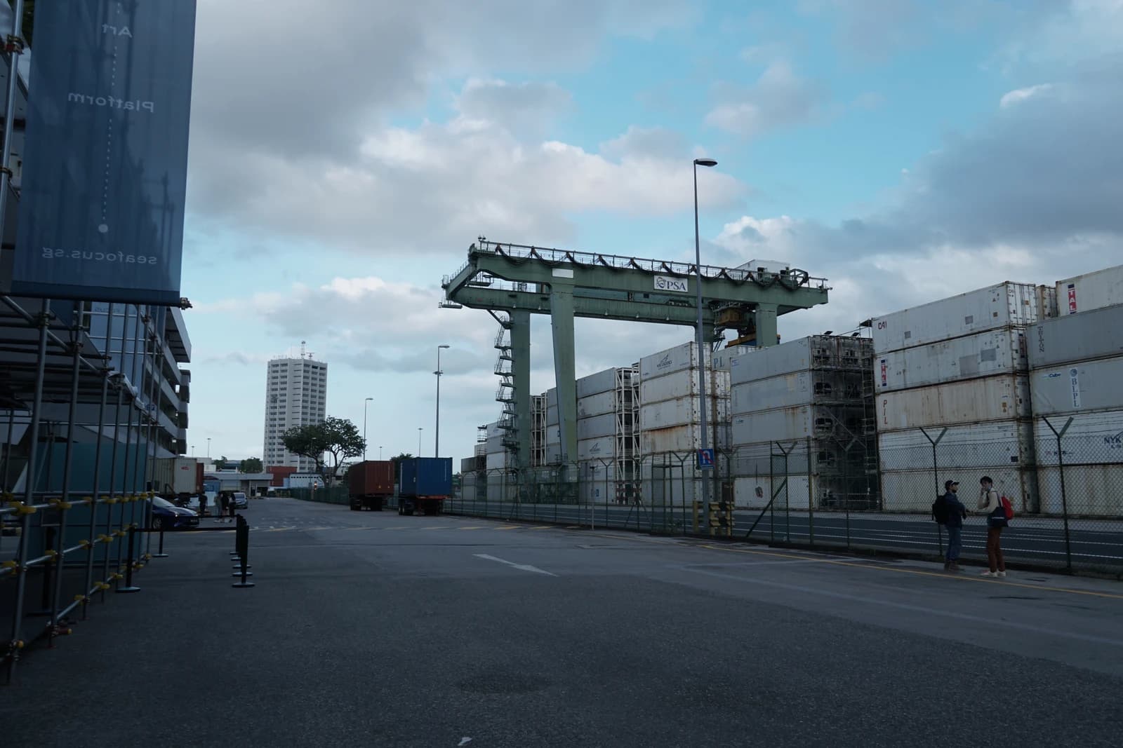 Tanjong Pagar Distripark with stacked shipping containers and a large gantry crane.