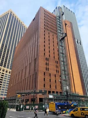 25 Water Street, a large brick building under renovation with scaffolding on its facade.