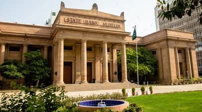 The neoclassical building of the State Bank Museum in Pakistan with a flag.