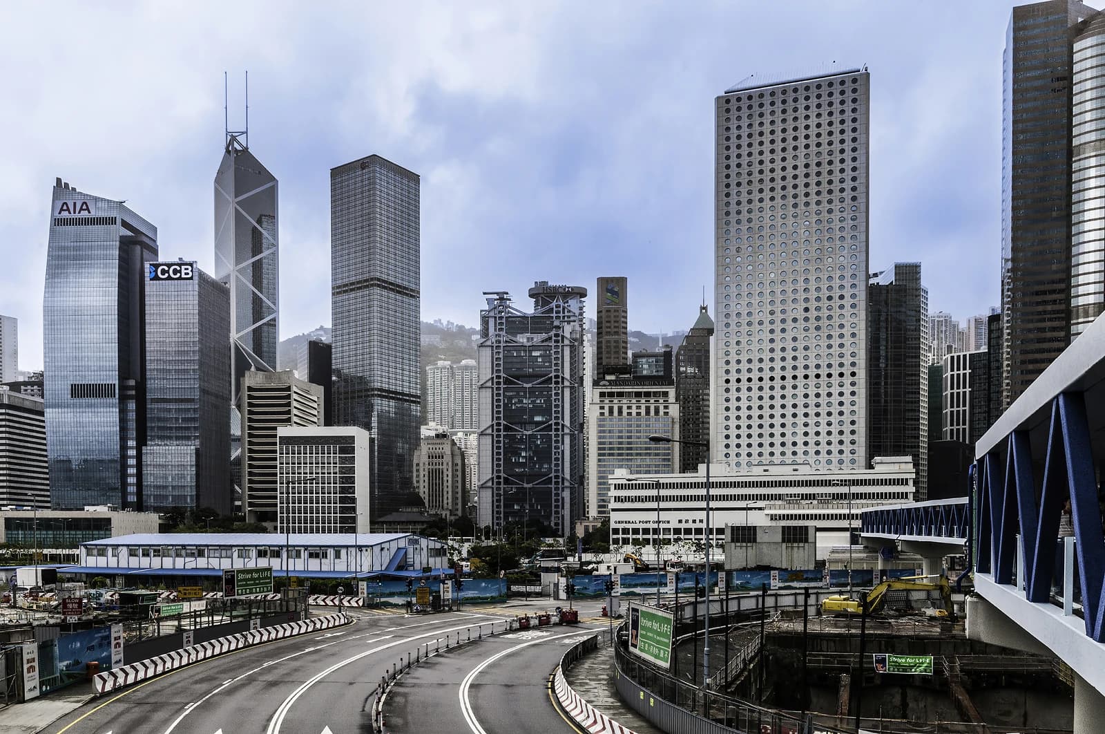 Skyscrapers of Hong Kong financial center with a road network and construction site.