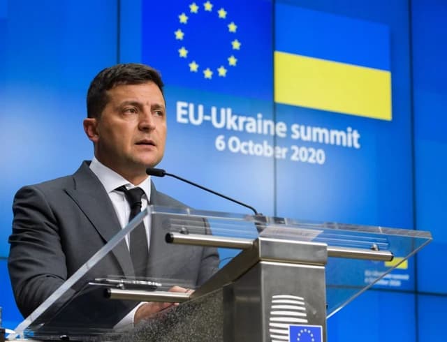 Volodymyr Zelenskyy, President of Ukraine, speaking at a podium.