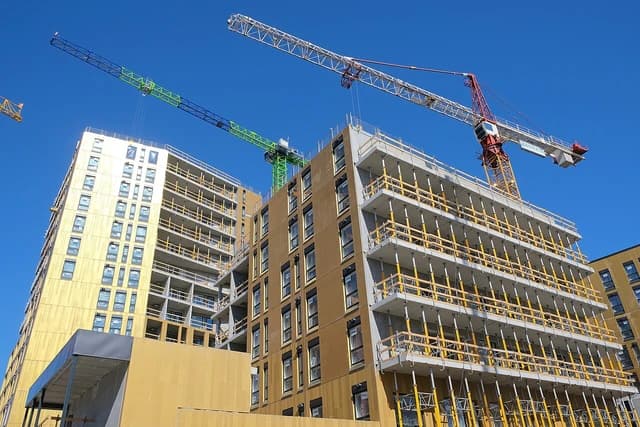 Apartment buildings under construction with cranes in Vuosaari, Helsinki.