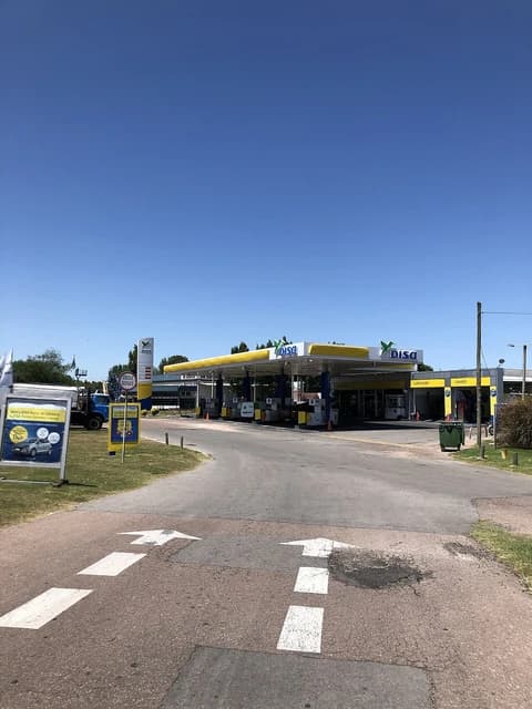 Disa petrol station with a yellow canopy and multiple fuel pumps in Carrasco.