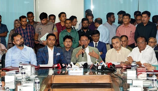 Ehsanul Haque Milan, former Member of Parliament, speaking into microphones at a press conference.