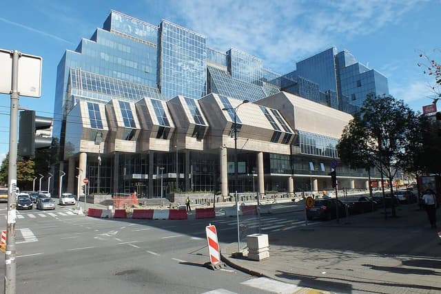 Exterior of the National Bank of Serbia building in Belgrade, facing a street with cars.