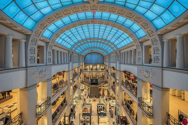 Interior of the DLT department store with a large atrium and multiple shopping levels.