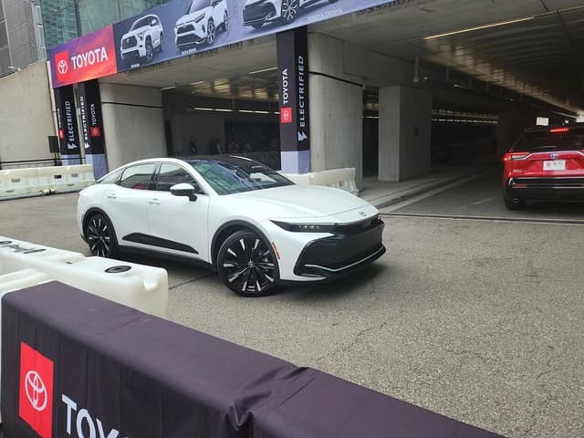 White Toyota Crown parked on pavement at the 2023 New York Auto Show.
