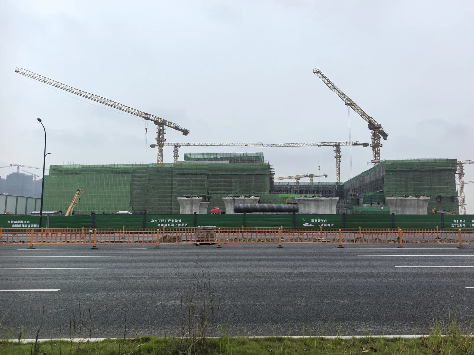 Qiantang Railway Station construction site in Hangzhou, China, featuring multiple cranes and scaffolding.