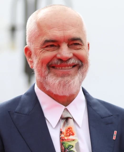 Edi Rama, Prime Minister of Albania, smiling while looking towards the viewer.