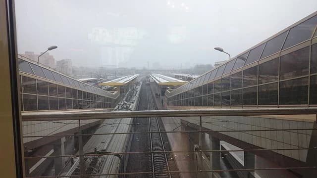 View from above showing train tracks, platforms, and a train at Minsk Train Station.