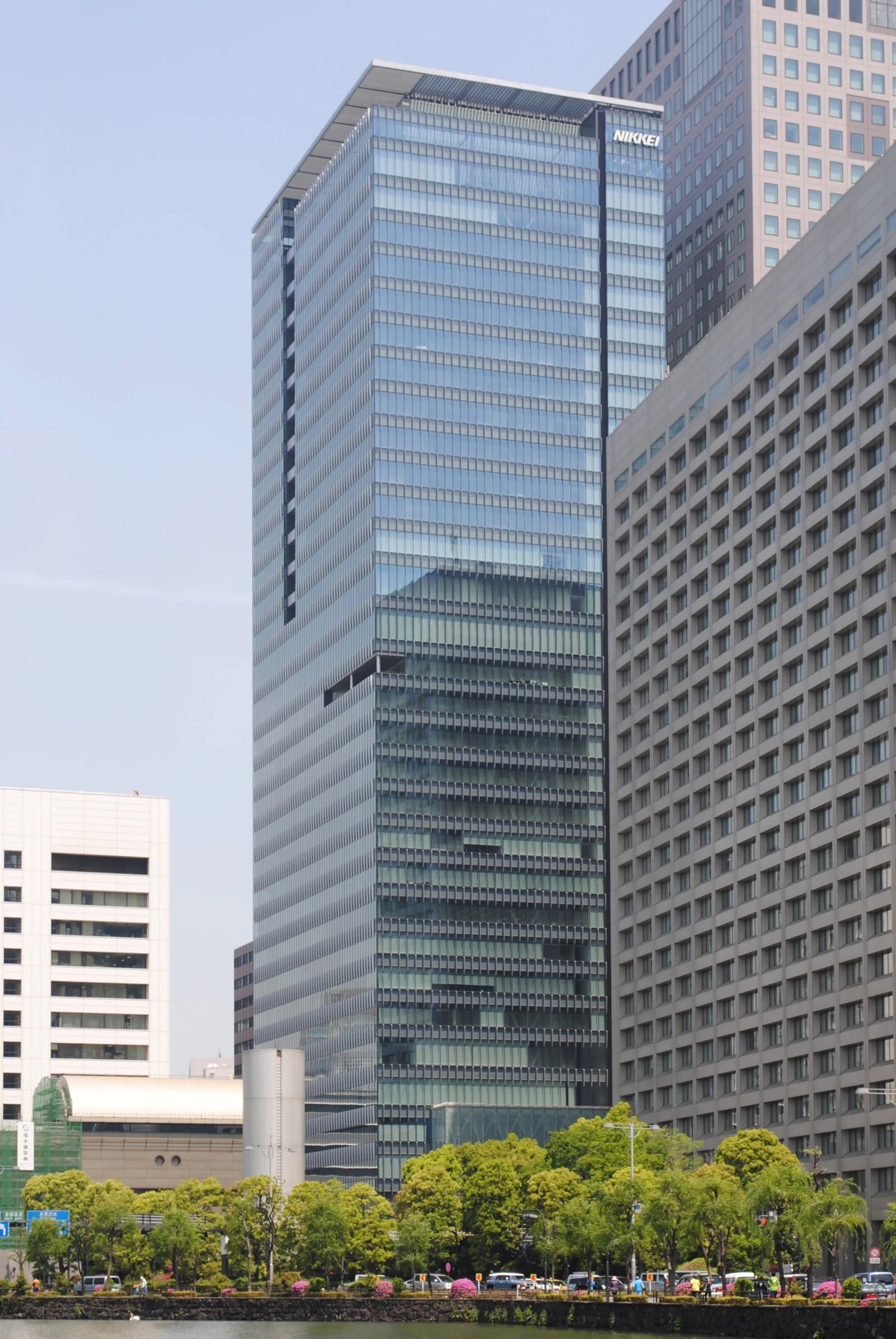 Exterior view of the tall, modern glass building of Nikkei Inc. headquarters in Tokyo.