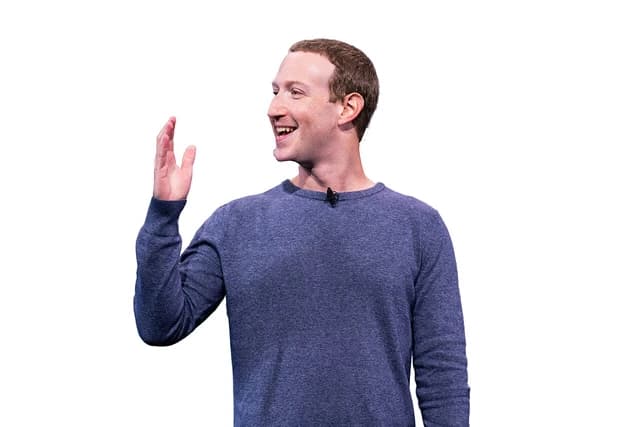 Mark Zuckerberg, CEO of Meta, gestures with his hand and smiles.