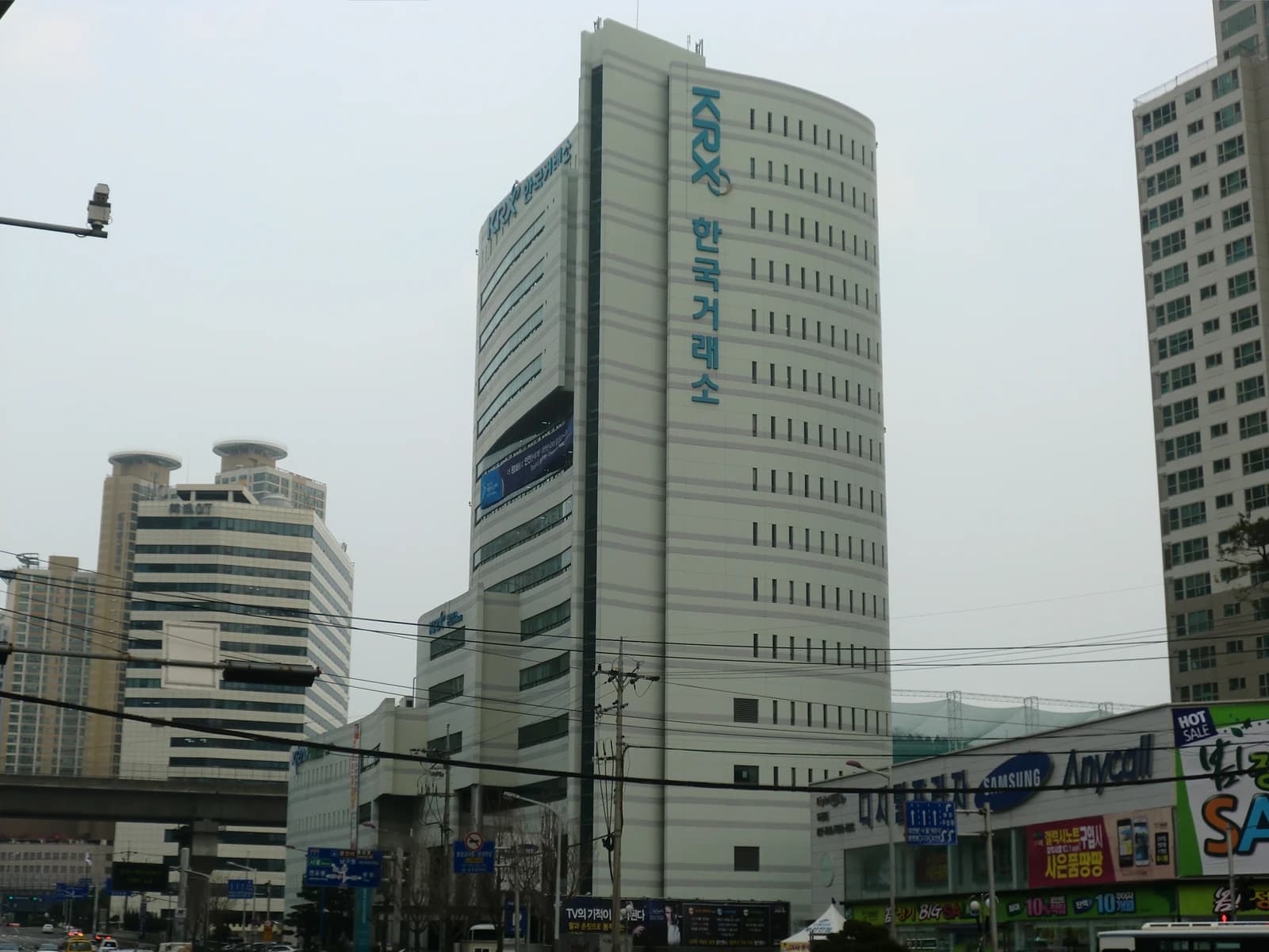 Exterior of the Korea Exchange building with 'KRX' and Korean text visible on its facade.