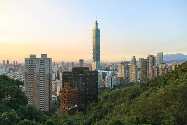Taipei 101 skyscraper standing tall amid other buildings in the Taipei city skyline.