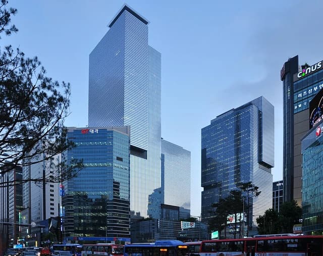 Samsung headquarters building stands tall among other buildings in a city street.