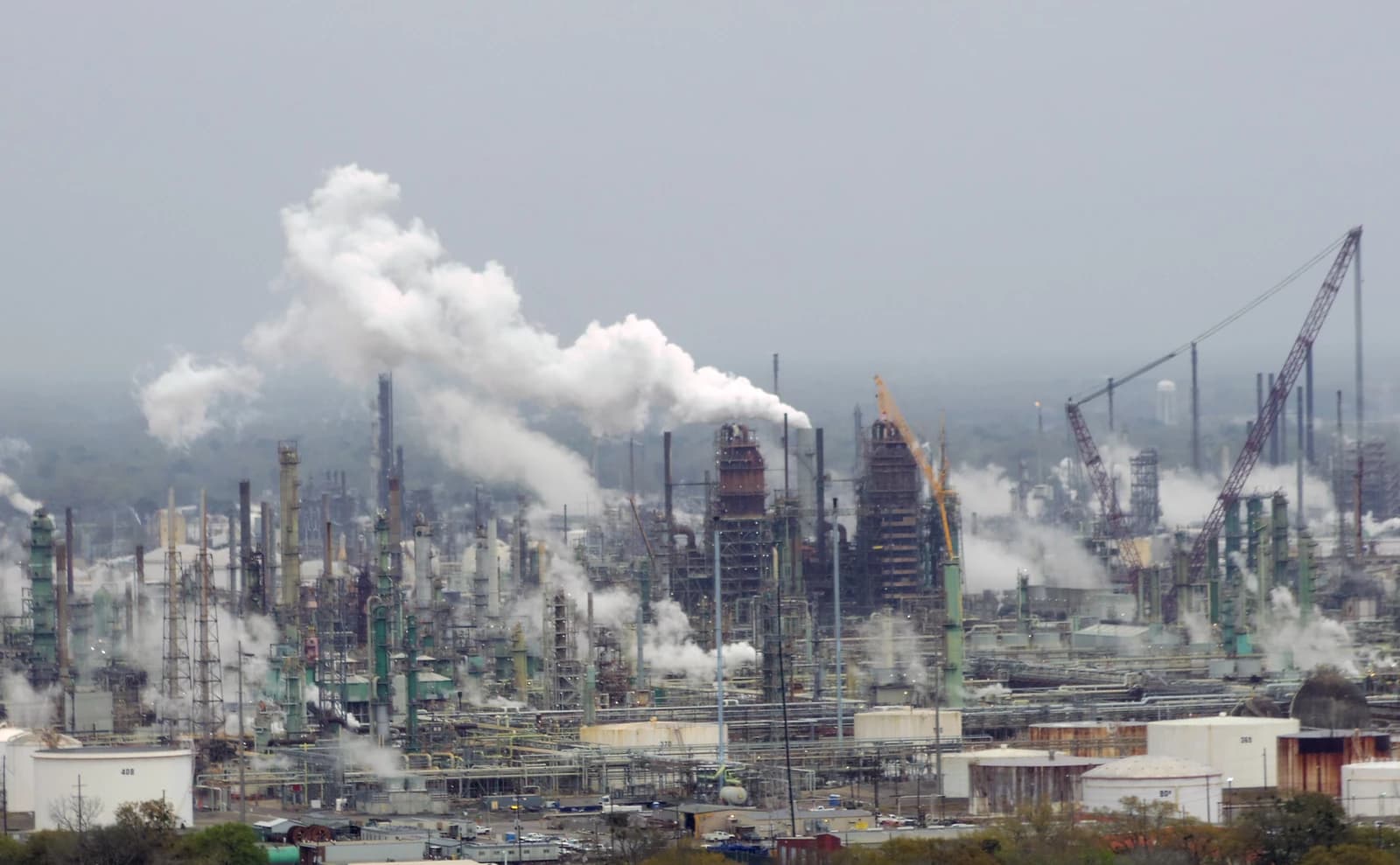Exxon Mobil oil refinery with industrial structures and smoke stacks, Baton Rouge, Louisiana.