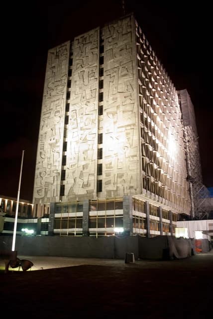 Banco de Guatemala building illuminated at night in Guatemala City.