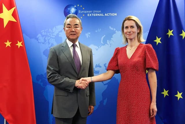China's top diplomat Wang Yi shaking hands with Estonian Prime Minister Kaja Kallas.