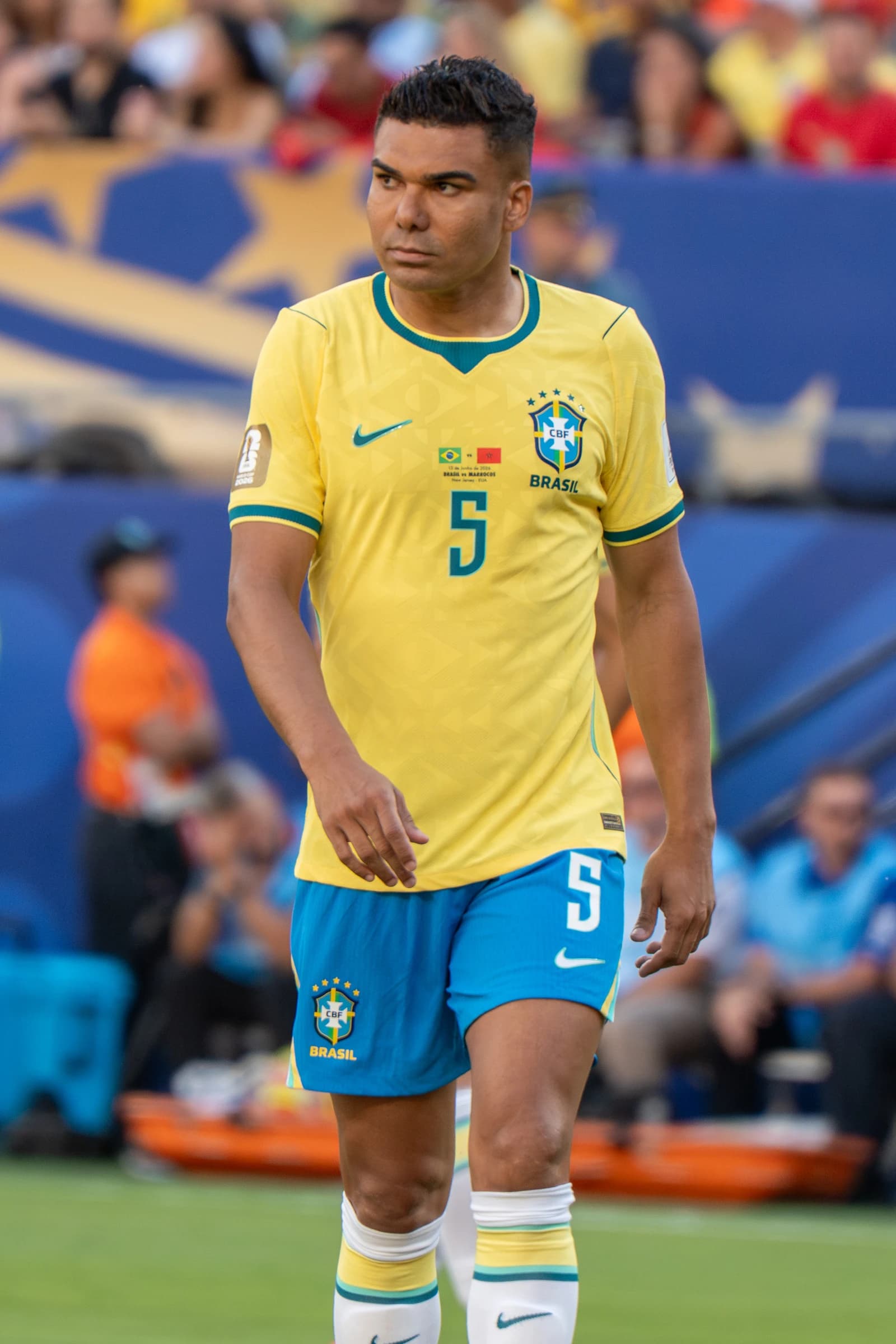 Casemiro, a Brazil national team player, stands on a soccer field during a match.
