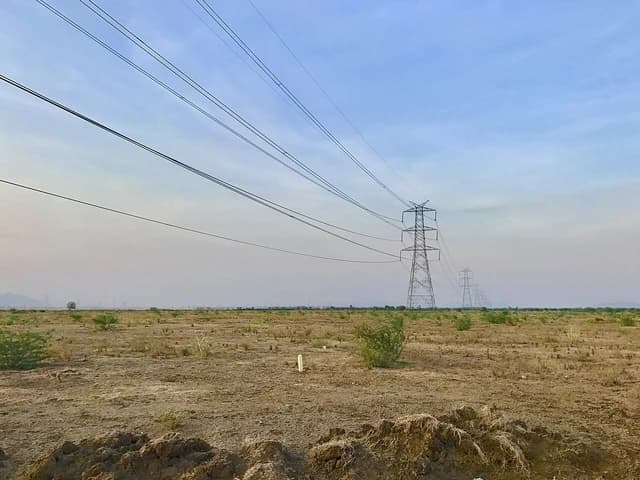 High voltage power lines and transmission towers in Amaravati, India.