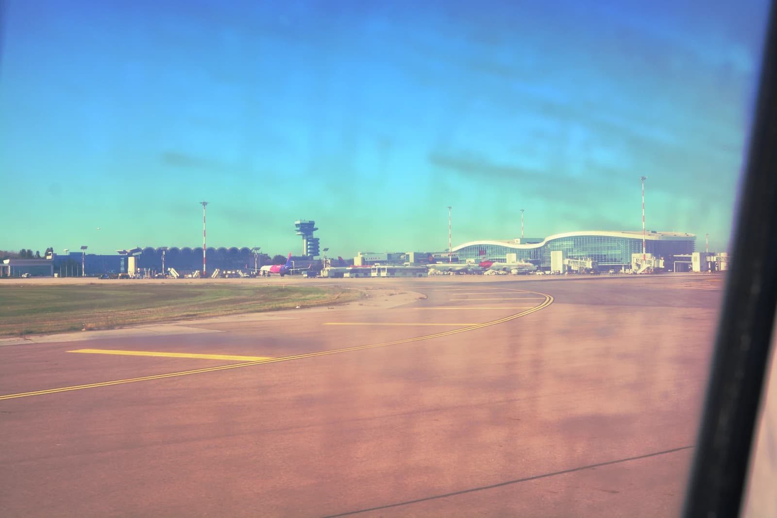 An airplane taxiing on the tarmac at Henri Coandă International Airport.
