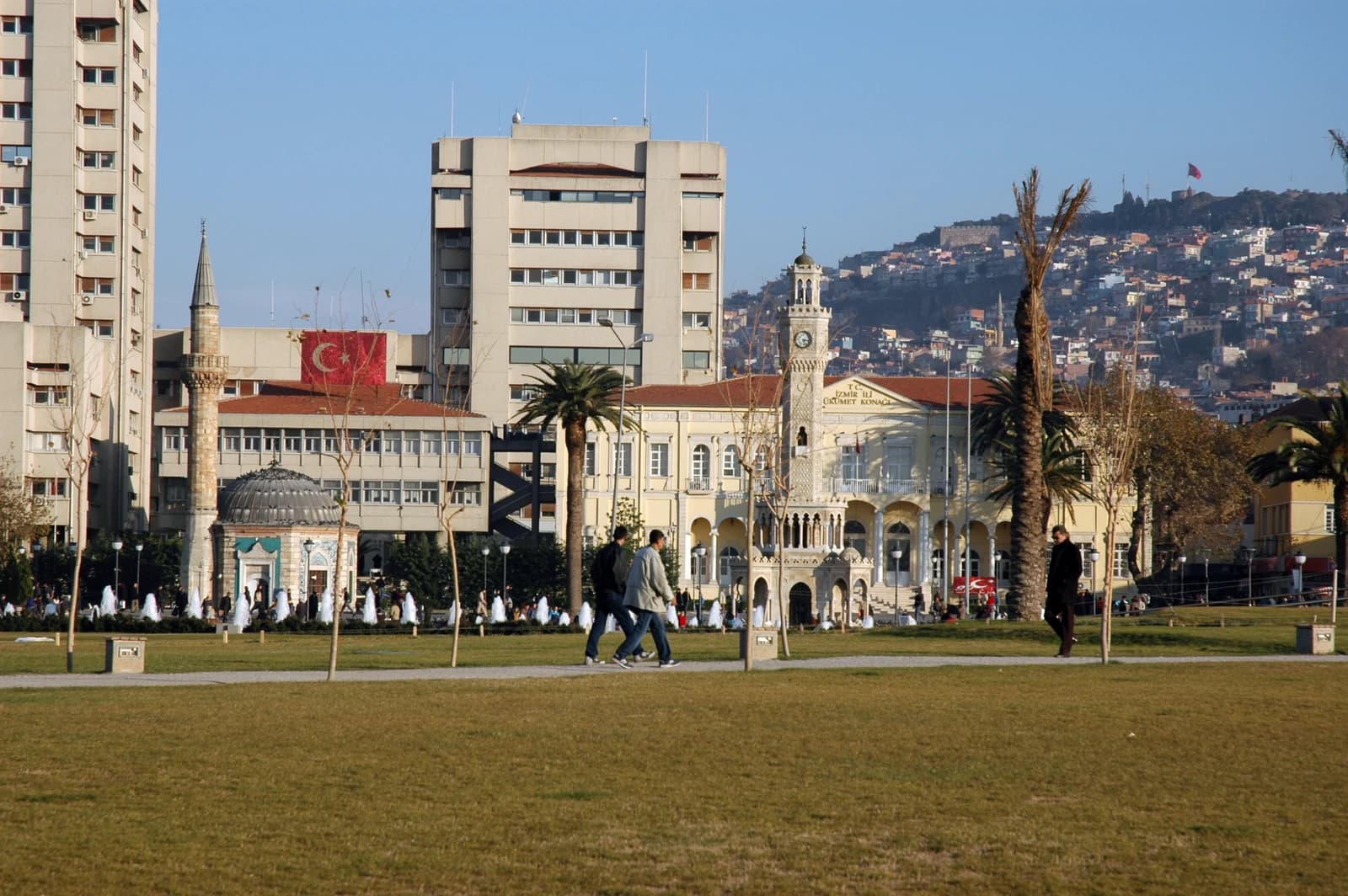 Izmir Provincial Government building and clock tower with distant hills and cityscape.