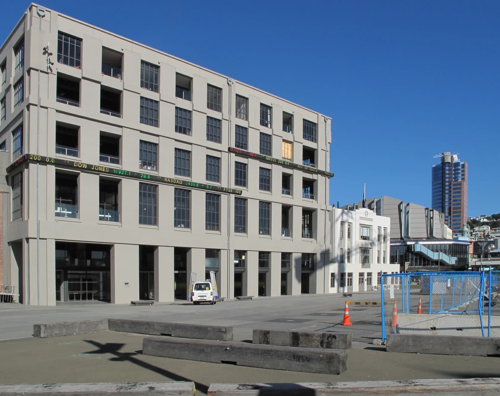 New Zealand Stock Exchange building exterior showing market ticker and surrounding area.