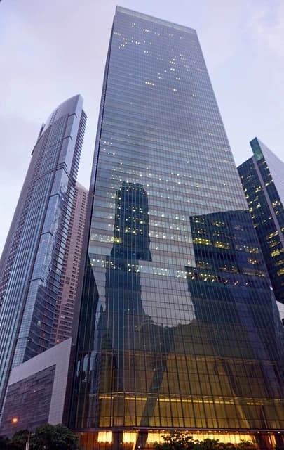 One Raffles Quay North Tower, a tall glass building, stands in Singapore's business district.
