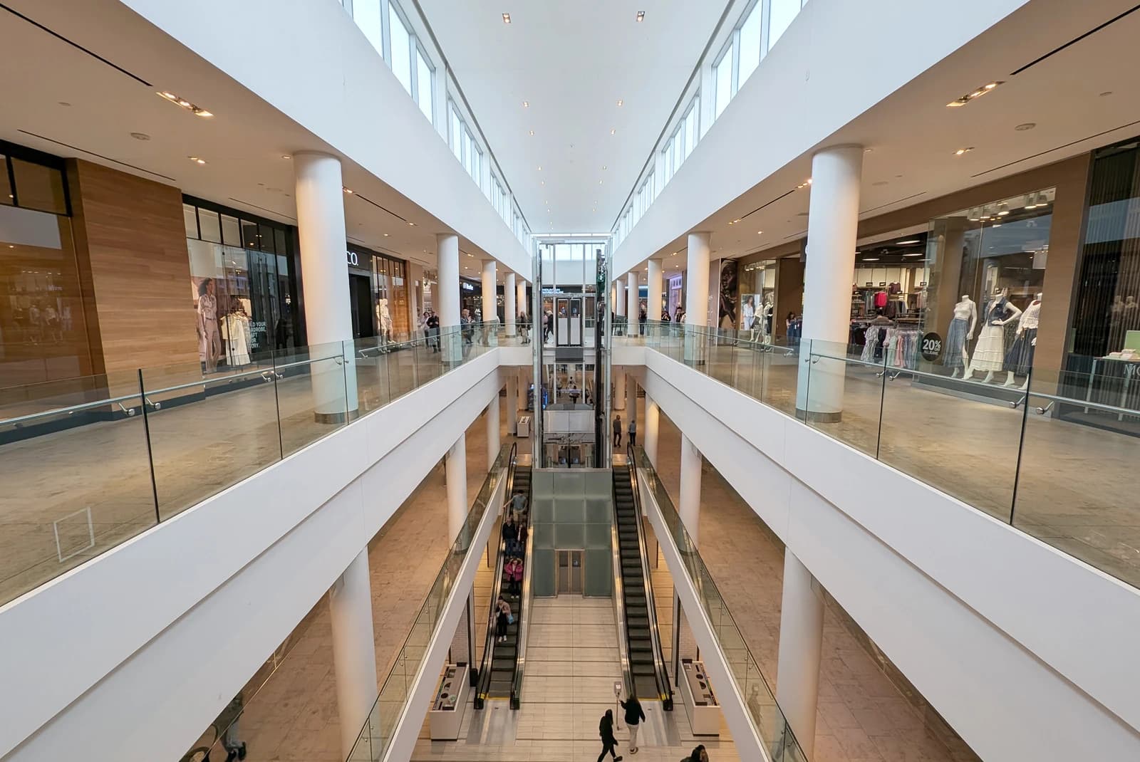 Interior of Halifax Shopping Centre with shoppers, escalators, and retail storefronts.