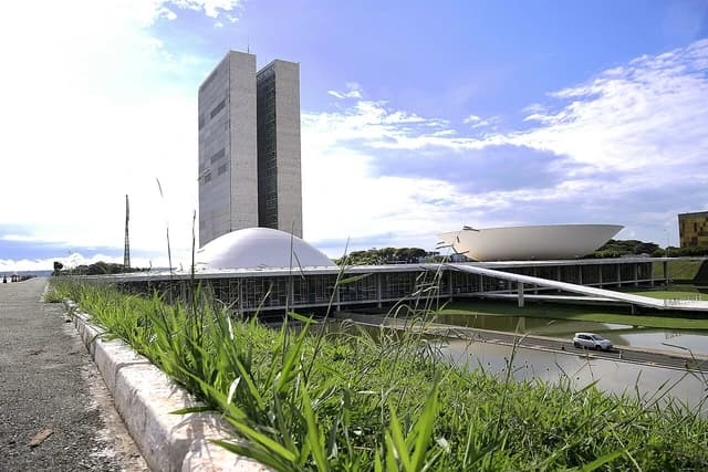 Exterior of the Palácio do Congresso Nacional in Brasília, Brazil, under a cloudy sky.