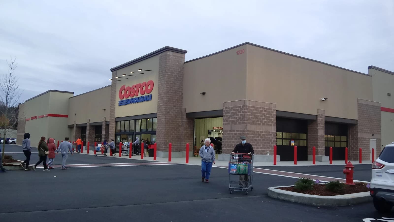 Exterior view of a Costco Wholesale Club building with its red logo visible.