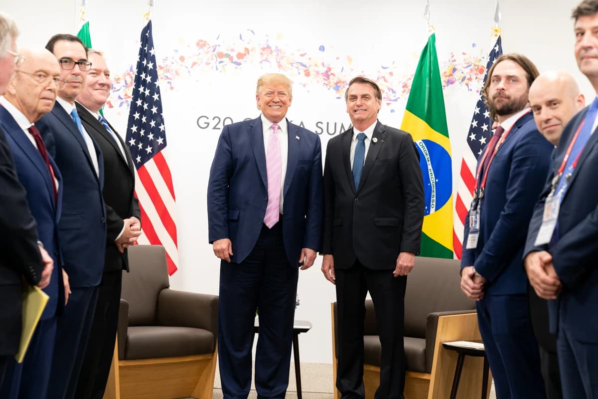 President Donald Trump and President Jair Bolsonaro smiling while standing next to each other.