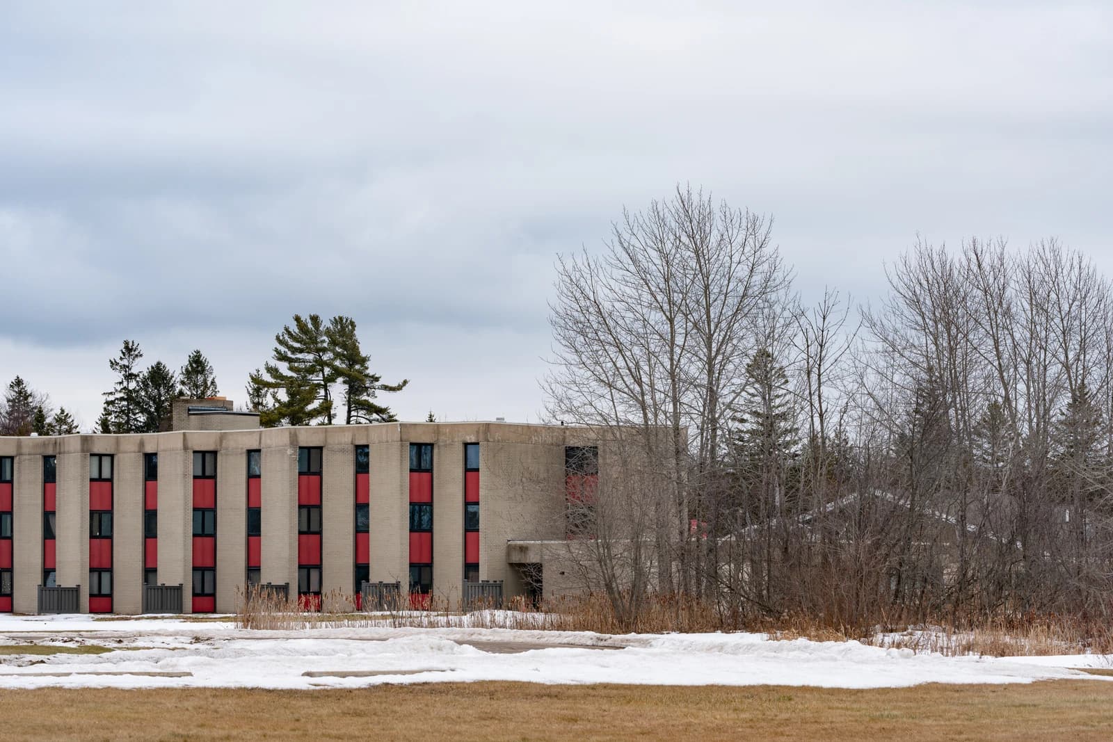 Exterior of Harbor View Towers, an affordable public housing building in Michigan, with snow on the ground.
