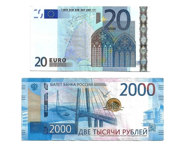 Twenty Euro banknote next to a two thousand Russian Ruble banknote.