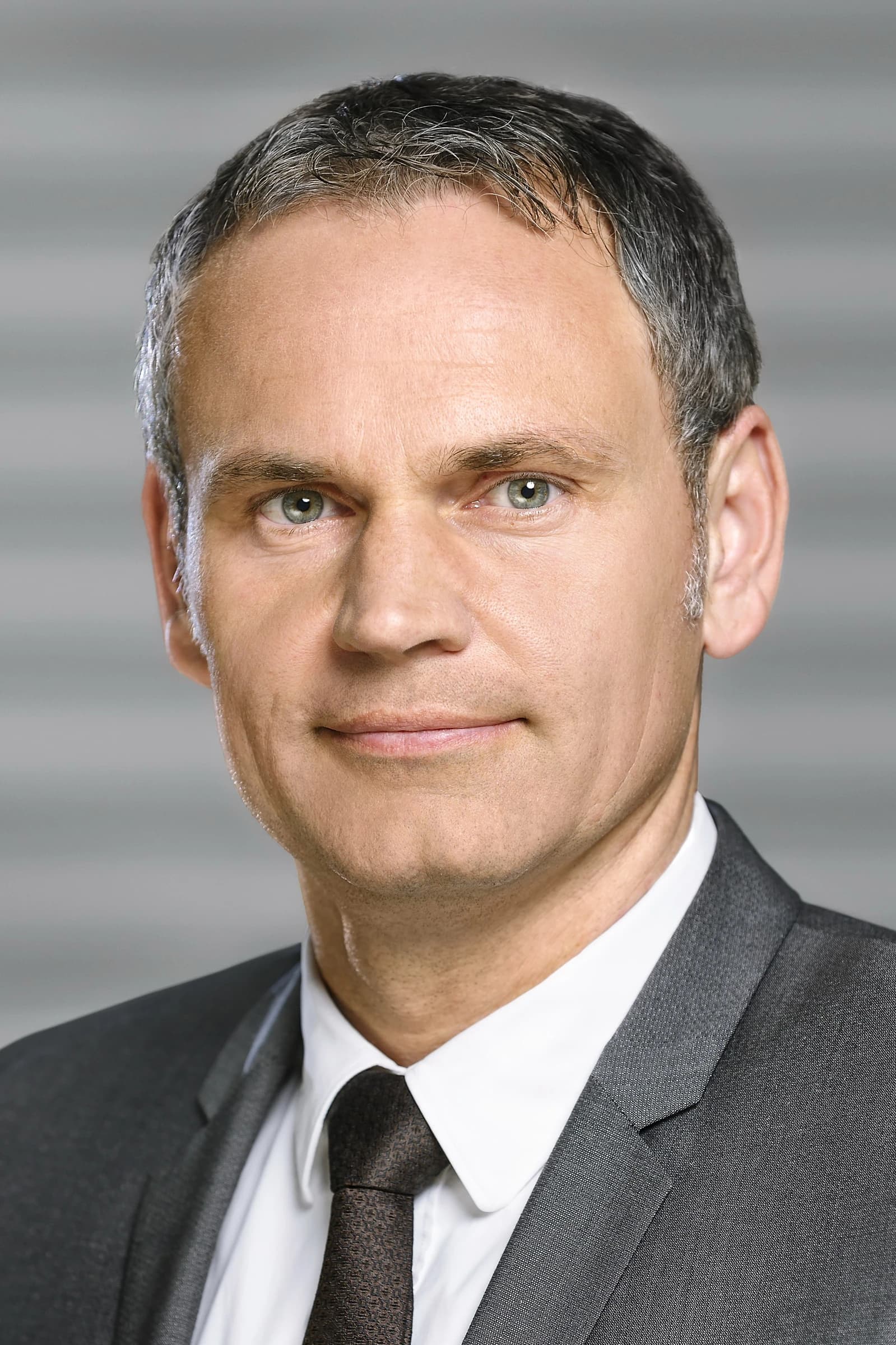 Dr. Oliver Blume, CEO of Porsche AG, facing the camera for a portrait.