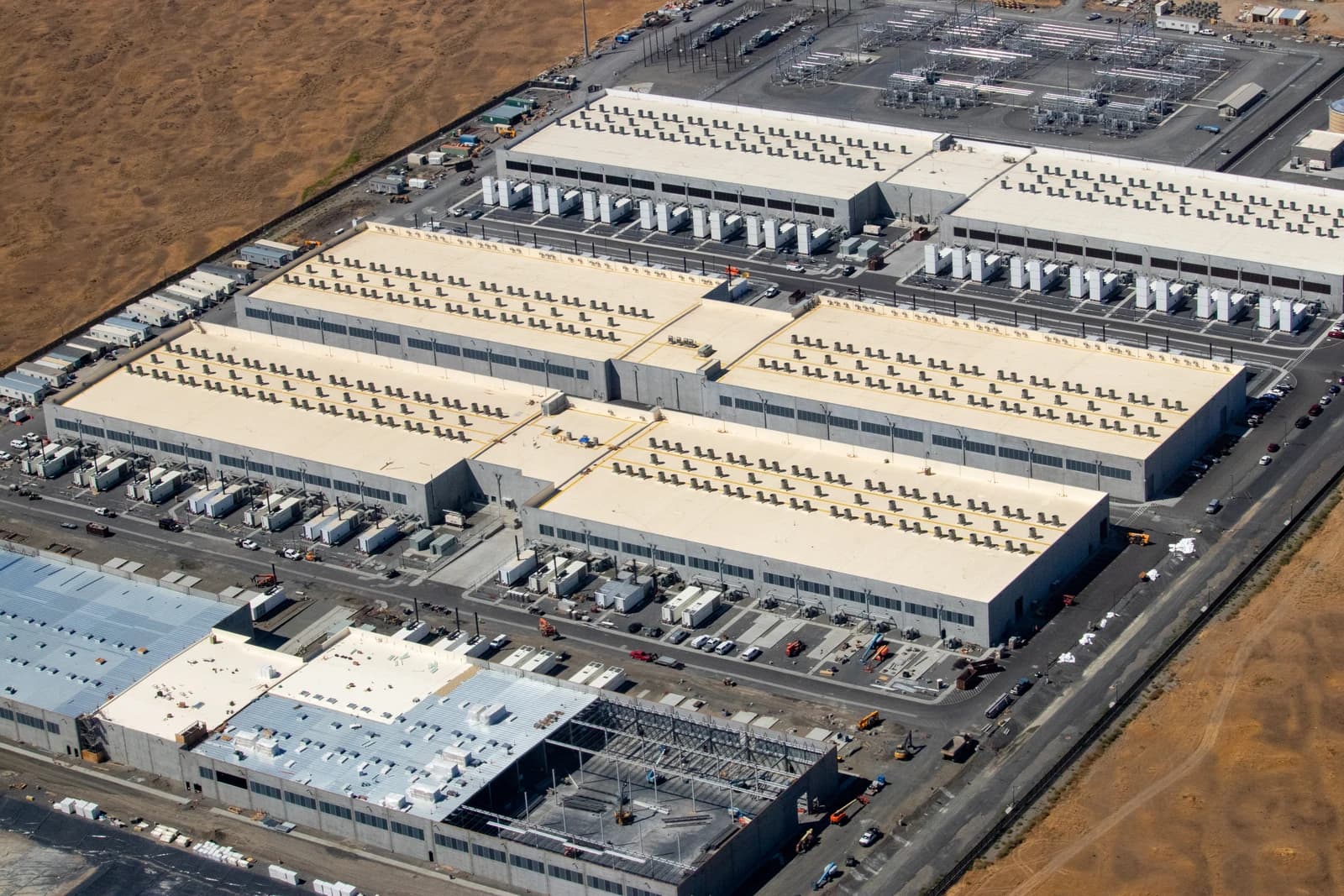 Aerial view of an Amazon AWS data center in an arid landscape.