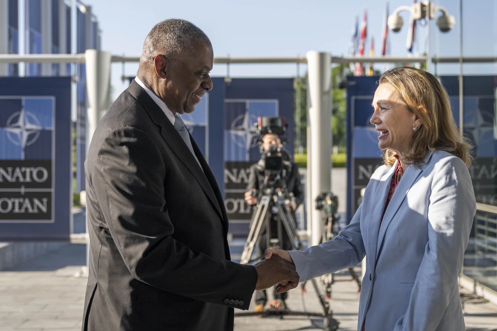 Lloyd Austin, United States Secretary of Defense, shaking hands with Julianne Smith, U.S. Permanent Representative to NATO.