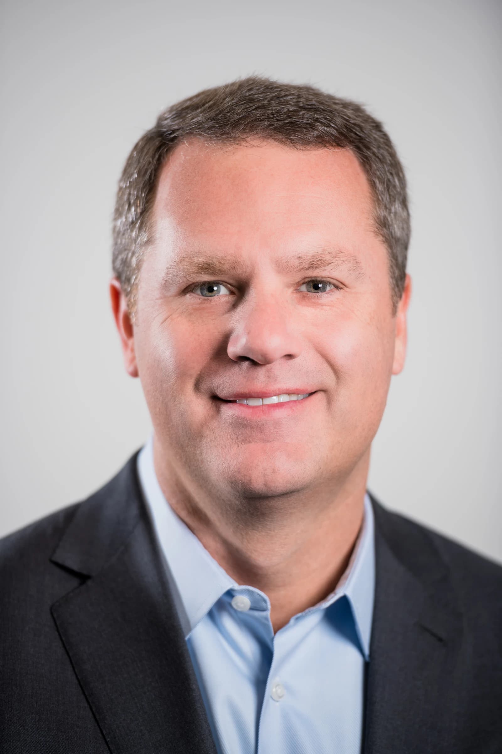 Doug McMillon, President and CEO of Walmart Inc., smiling at the camera.