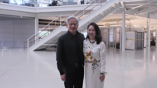NVIDIA Founder and CEO Jensen Huang with Director Lê Nguyễn Thiên Nga standing in a modern office space.