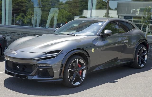 2024 Ferrari Purosangue, a gray SUV, parked on a sunny day.