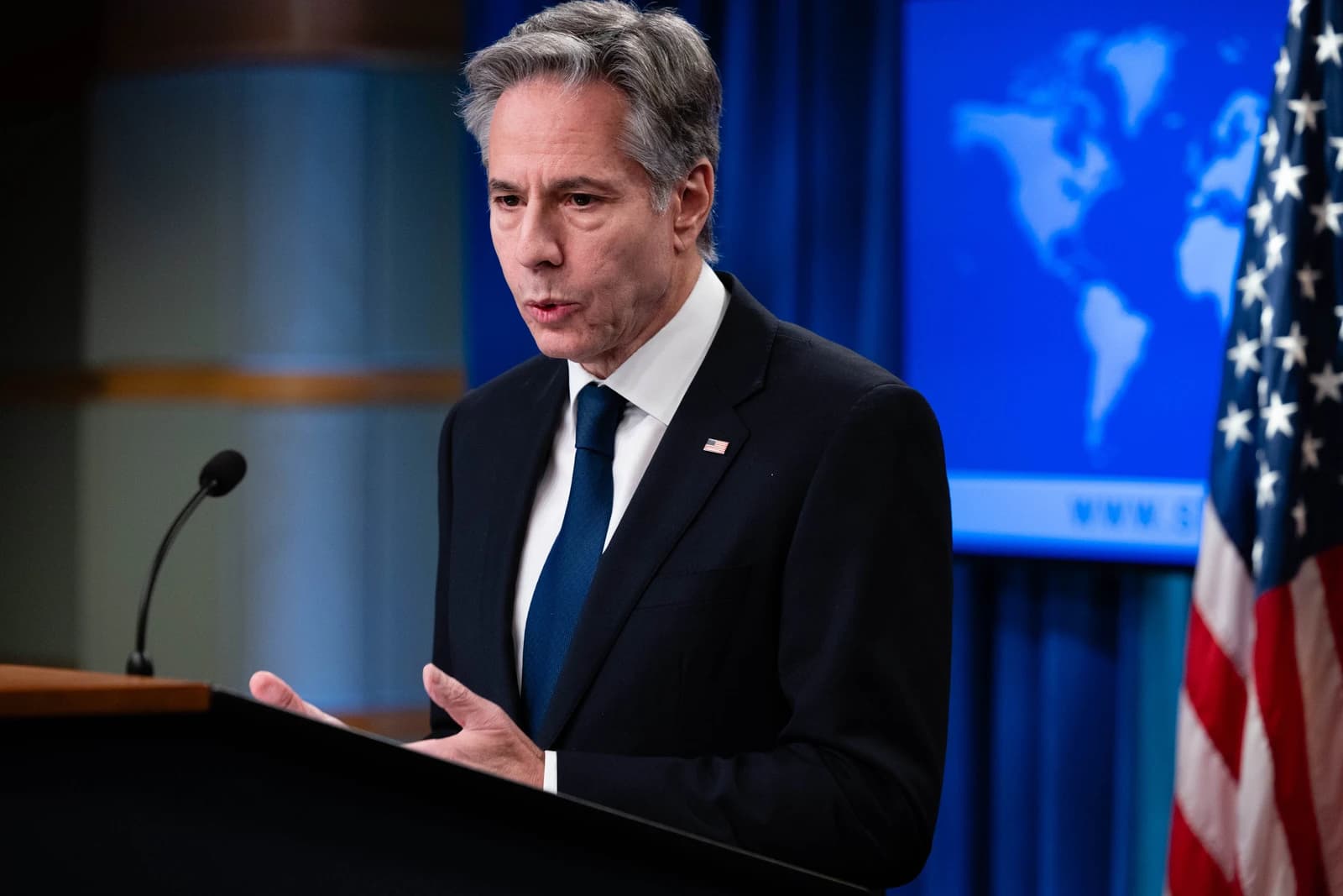 United States Secretary of State Antony J. Blinken speaks from a podium at the Department of State.