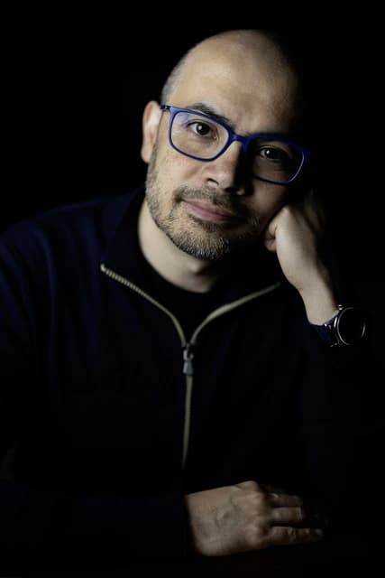 Demis Hassabis, scientific director of Alphabet, seated and looking directly at the viewer.